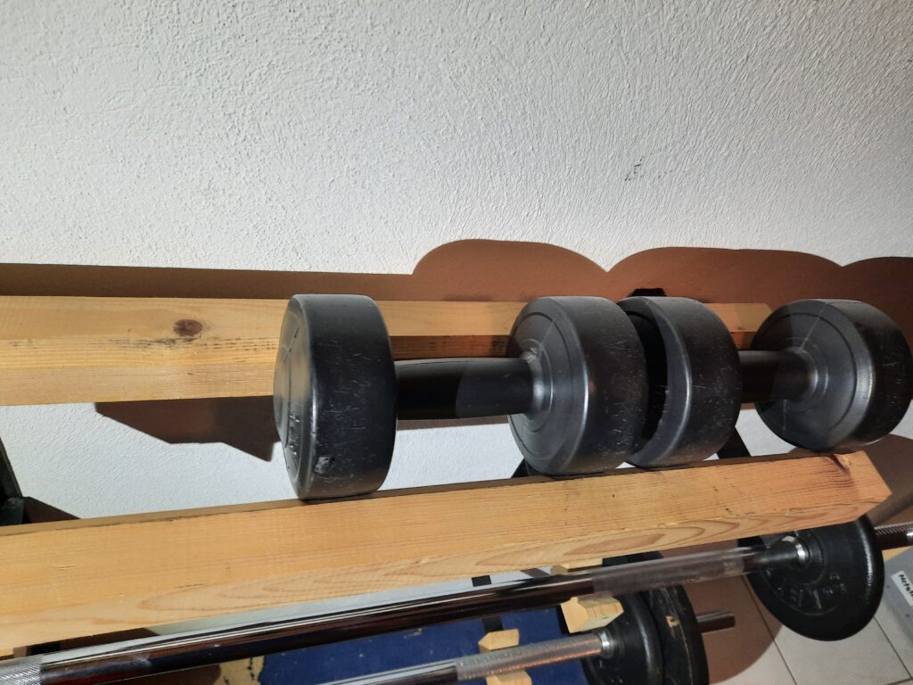 Lang- und Kurzhantel Ablage: Massive Ablage für die Wandmontage. Mit dekorativen und funktionellen Holzelementen schonend für verchromte Chromhantelstangen.